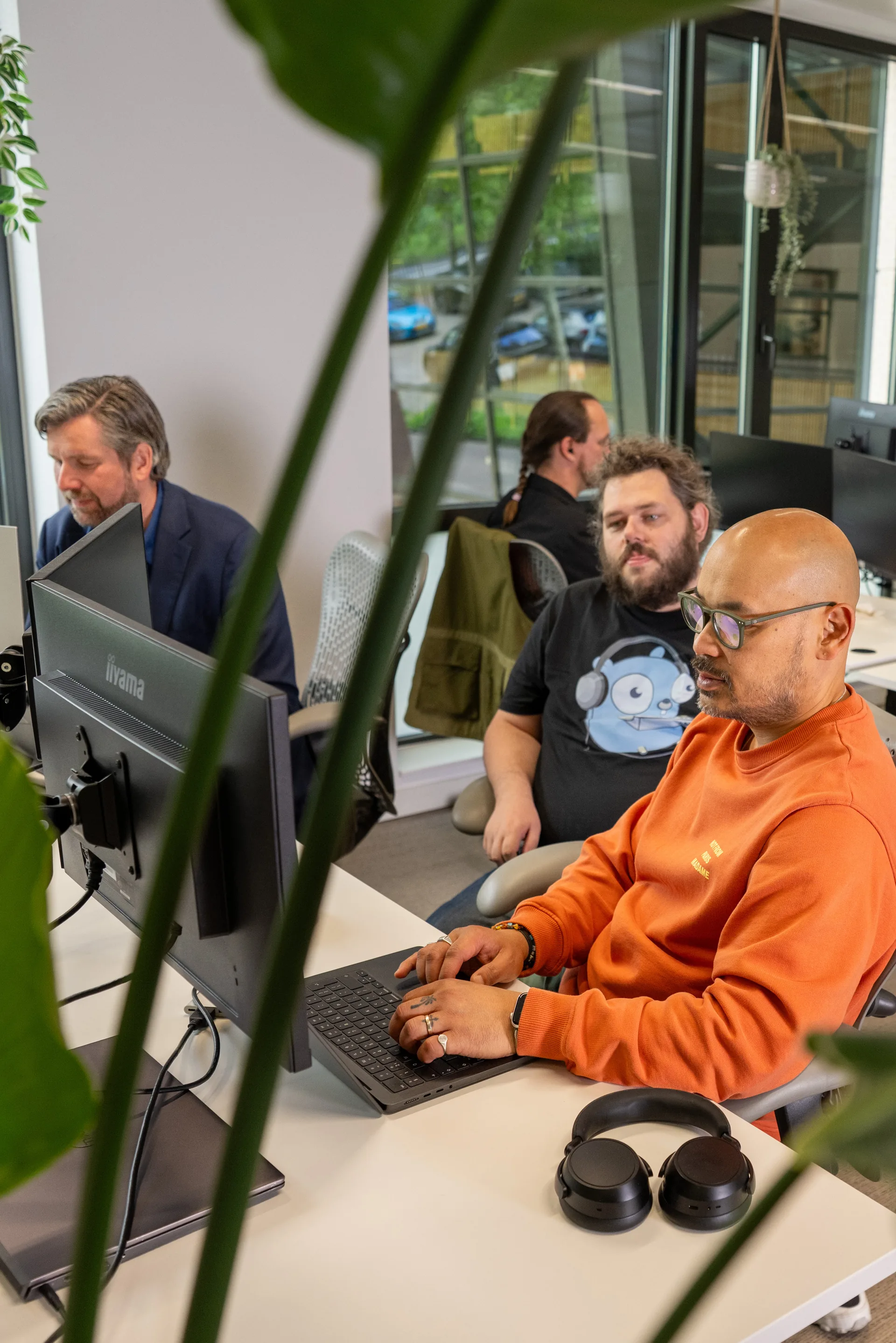 Emendis-ontwikkelaars aan het werk in de open kantooromgeving met veel groen